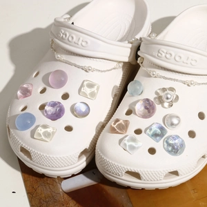 Close-up of glittery water ripple shoe charms and pearl chains for DIY clogs decoration