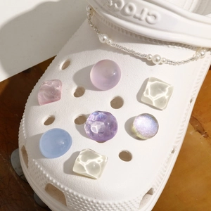 Close-up of glitter water ripple charms and pearl chain for clog shoes DIY decoration