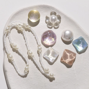 Detail of iridescent crystal pearls and water ripple gems for DIY shoe charms and accessories