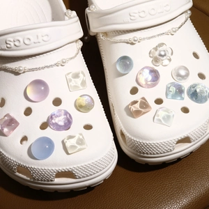 Detail of iridescent resin charms and pearl chains for DIY garden clog decoration