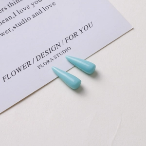Macro view of light blue resin teardrop pendants for DIY jewelry and earring making