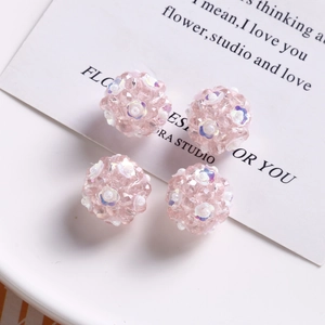 Detailed view of handmade pink floral glass beads with multi-faceted cut for DIY jewelry