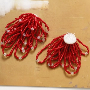 Detail of handmade red seed bead fringe with crystal accents and white felt backing