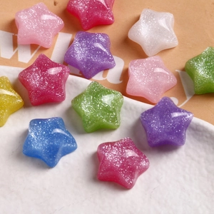 Macro view of colorful glitter star-shaped resin charms for DIY jewelry and crafts
