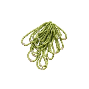 Handmade beaded flower accessory with light green crystal fringe tassels on white backdrop
