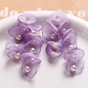 Detail of lavender organza petal earrings with pearls on a golden metal fringe
