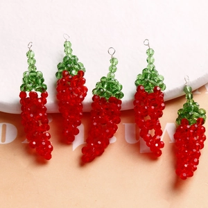 Five handmade red glass bead chili charms with green leaves and metal loops for DIY jewelry