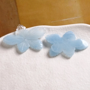 Macro shot of two light blue resin flower petals with translucent gradient texture