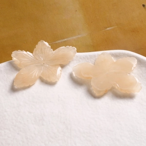 Macro detail of peach pink resin flower beads with petal texture for DIY jewelry making