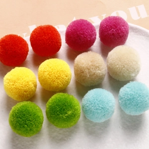 Close-up of colorful 20mm plush pom pom balls for DIY jewelry and hair accessories
