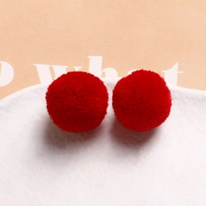 Detail of red 20mm fluffy pom-poms for DIY jewelry and hair accessory crafting