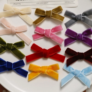 Close-up of 12 colorful velvet ribbon bows arranged neatly for DIY hair accessory projects