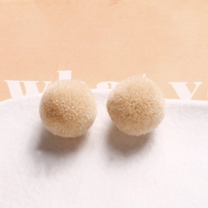 Detail of soft 20mm beige plush pom-pom balls for DIY handmade jewelry crafts