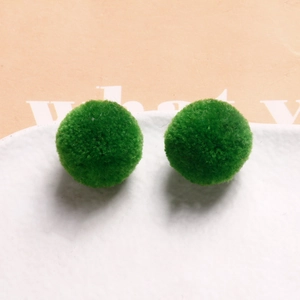 Detailed macro view of soft green plush round beads for DIY handmade jewelry crafts