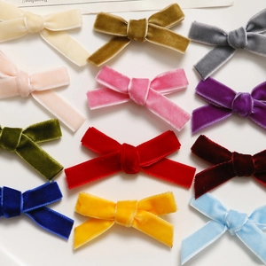 Close-up of assorted colorful velvet bow hair clips with soft texture and refined stitching
