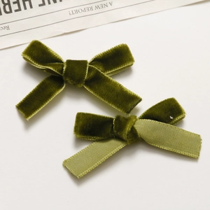 Close-up of vintage green velvet and ribbed ribbon handmade bow hair clips for women