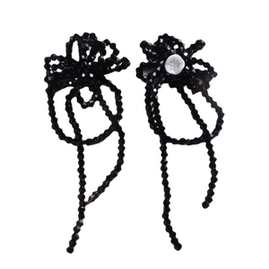 Handmade black beaded flower earrings with long glass tassel fringe on white background