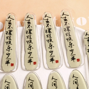 Close-up of transparent acrylic hairpins with Chinese ink calligraphy on a white plate