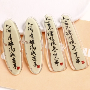 Macro detail of acrylic DIY accessories with Chinese calligraphy and red seal stamps