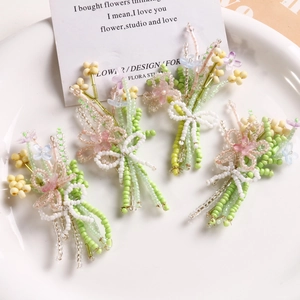Handmade bead woven flower bouquet brooches in green, pink, and yellow for DIY fashion