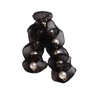 Handmade black mesh flower earrings with white pearls and gold accents on white background