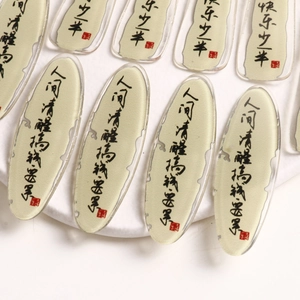 Macro view of Chinese calligraphy acrylic charms with traditional red seals