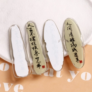 Close-up of acrylic resin charms featuring creative Chinese calligraphy and red seal details