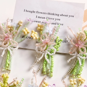 Handmade beaded flower accessories with pink petals and green stems for DIY jewelry making