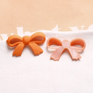 Détails de breloques nœuds orange en acrylique dépoli pour création de bijoux DIY