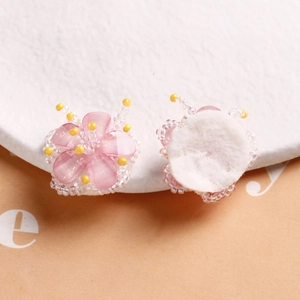 Detail of pink beaded flower with yellow core and felt back for DIY hair accessories