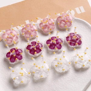 Handmade woven glass bead flower charms in pink, purple, and white for DIY jewelry