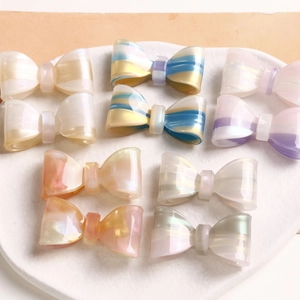 Detailed close-up of translucent glitter bow-shaped resin hair clip accessories in macaron tones