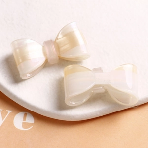 Close-up of double-layered acetate bow hair accessories with pearly striped texture