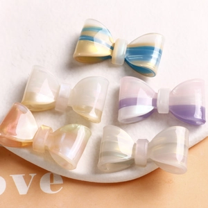Colorful glitter acetate bow hair clips set on marble tray with pearlescent finish