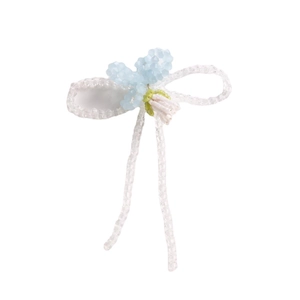 Handmade clear beaded bow hair accessory with a light blue flower and green accents