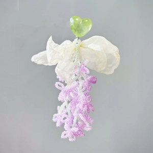 Fairy style earrings with green heart, white bow, and purple beaded tassel dangles