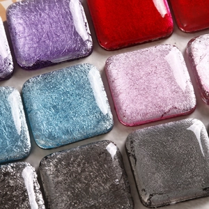 Detail of square resin charms with colorful foil crackle patterns for DIY accessories