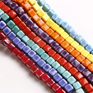 Macro shot of 9mm colorful glossy square ceramic beads with central holes for DIY jewelry