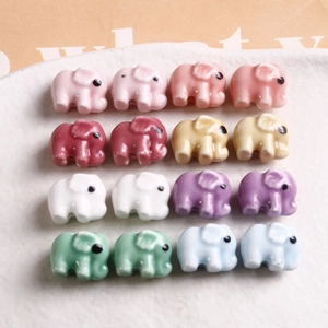 Macro shot of colorful glazed ceramic elephant beads for DIY jewelry crafts