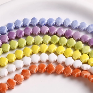 Colorful 12mm shell-shaped ceramic beads arranged in rows for DIY jewelry making