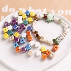 Macro shot of colorful 9mm ceramic cube beads and starfish charms for DIY jewelry making