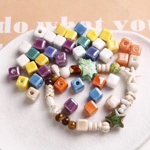 Macro shot of colorful ceramic beads in star, square, and leaf shapes for DIY jewelry making