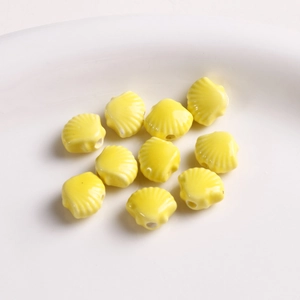 Detail of 12mm yellow fan-shaped shell ceramic beads with hole for DIY jewelry making