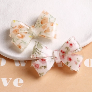 Sweet floral acrylic bow hair clips with delicate pink and orange flower patterns