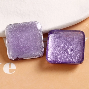 Macro detail of square purple resin charms with silver foil inlay for DIY jewelry