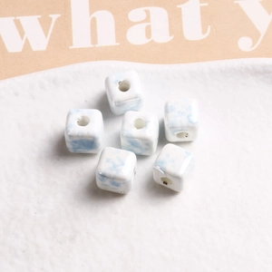 Macro view of 9mm square ceramic beads with blue marble texture for DIY jewelry making