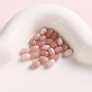 Detailed close-up of 6mm oval pink natural stone beads for DIY jewelry making