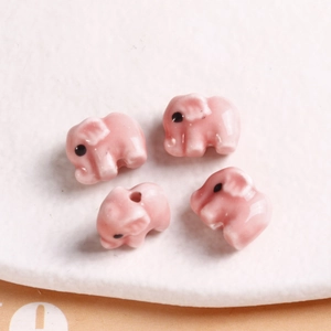 Macro shot of pink ceramic elephant beads for DIY jewelry making and bracelets