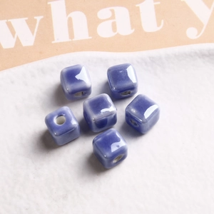 Macro shot of 9mm square gradient purple glazed ceramic beads with pre-drilled holes