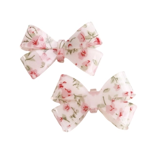 Pair of sweet pink floral bow resin hair clips with elegant leaf pattern on white background